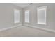 Bright and airy bedroom featuring plush carpet and white trim around the windows at 151 Cobble Ridge Dr, Pittsboro, NC 27312