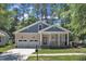 Charming home with a welcoming front porch, well-manicured lawn, and two-car garage at 151 Cobble Ridge Dr, Pittsboro, NC 27312