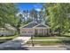 Beautiful front exterior of a home with a cozy porch, lush lawn, and convenient two-car garage at 151 Cobble Ridge Dr, Pittsboro, NC 27312
