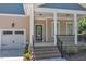 Close-up of the welcoming front porch with brick steps and black railing leading to a black front door at 151 Cobble Ridge Dr, Pittsboro, NC 27312