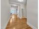 Bright hallway featuring hardwood flooring and white trim leading to various rooms at 151 Cobble Ridge Dr, Pittsboro, NC 27312