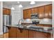 Modern kitchen featuring dark cabinets and stainless steel appliances at 151 Cobble Ridge Dr, Pittsboro, NC 27312
