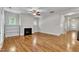 Spacious living room featuring hardwood floors, fireplace, and access to other rooms at 151 Cobble Ridge Dr, Pittsboro, NC 27312