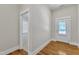 Bright room featuring hardwood floors, a white door, and a doorway leading to another room at 151 Cobble Ridge Dr, Pittsboro, NC 27312