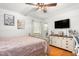 Bright bedroom featuring hardwood floors, a ceiling fan, and a flat screen TV at 1703 Keogh St, Burlington, NC 27215
