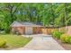 Charming single-story brick home featuring an attached garage, extended driveway and a beautiful fenced yard at 1703 Keogh St, Burlington, NC 27215