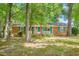 Charming brick home with mature trees, shutters, and covered front porch at 1703 Keogh St, Burlington, NC 27215
