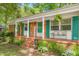 Inviting front porch with colorful shutters, brick steps, and decorative bench at 1703 Keogh St, Burlington, NC 27215