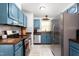 Efficient kitchen featuring blue cabinets, stainless appliances, and butcher block countertops at 1703 Keogh St, Burlington, NC 27215