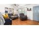 Bright living room with hardwood floors, striped curtains and comfortable seating at 1703 Keogh St, Burlington, NC 27215
