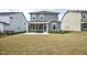 View of the backyard featuring a screened porch, and well-maintained lawn at 1740 Golden Honey Dr, Wake Forest, NC 27587
