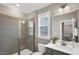 Neutral bathroom featuring a tiled shower, a single vanity and ample natural light at 1740 Golden Honey Dr, Wake Forest, NC 27587
