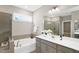 Bathroom featuring double vanity, soaking tub, glass shower and neutral color scheme at 1740 Golden Honey Dr, Wake Forest, NC 27587