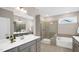 Well-lit bathroom featuring a double vanity, separate tub and shower, and neutral color palette at 1740 Golden Honey Dr, Wake Forest, NC 27587