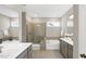 Bathroom with double sinks, separate tub and shower, and neutral tile at 1740 Golden Honey Dr, Wake Forest, NC 27587