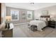 Bedroom with a tray ceiling, carpet flooring, and plenty of natural light from multiple windows at 1740 Golden Honey Dr, Wake Forest, NC 27587