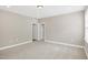 Carpeted bedroom with two doorways and one window for natural light at 1740 Golden Honey Dr, Wake Forest, NC 27587