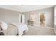 Large bedroom with a neutral color palette and adjoining bathroom at 1740 Golden Honey Dr, Wake Forest, NC 27587