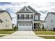 Charming two-story home with a gray exterior, white trim, and a two-car garage at 1740 Golden Honey Dr, Wake Forest, NC 27587