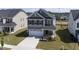A beautiful two-story house features a two-car garage, landscaping, and a welcoming entryway at 1740 Golden Honey Dr, Wake Forest, NC 27587