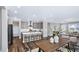 Open-concept kitchen boasts an island with seating, stainless steel appliances, and modern finishes at 1740 Golden Honey Dr, Wake Forest, NC 27587