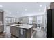 The open layout shows the kitchen with a breakfast bar, stainless dishwasher, and access to living spaces at 1740 Golden Honey Dr, Wake Forest, NC 27587