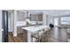 Open concept kitchen with stainless steel appliances, kitchen island, and breakfast bar seating at 1740 Golden Honey Dr, Wake Forest, NC 27587