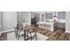 Bright open kitchen features an island with seating and stainless appliances adjacent to the dining area at 1740 Golden Honey Dr, Wake Forest, NC 27587