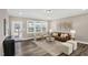 Living room with a brown couch, white chairs, a decorative rug, and luxury vinyl flooring at 1740 Golden Honey Dr, Wake Forest, NC 27587