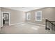 Well-lit upstairs loft area with carpet floors and natural light from two windows at 1740 Golden Honey Dr, Wake Forest, NC 27587