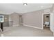 Upstairs loft space featuring carpet floors and a laundry sink area at 1740 Golden Honey Dr, Wake Forest, NC 27587