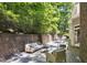 Backyard deck featuring brick detailing and ample room for outdoor seating and entertaining at 201 Red Bud Ln, Chapel Hill, NC 27514