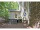 Exterior view of the back of the house with lush backyard landscaping at 201 Red Bud Ln, Chapel Hill, NC 27514