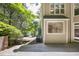 An exterior view of the home's wooden deck, surrounded by lush green landscaping at 201 Red Bud Ln, Chapel Hill, NC 27514