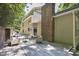 A back deck featuring lounge seating, dining sets, and beautiful landscaping surrounds the home at 201 Red Bud Ln, Chapel Hill, NC 27514