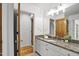 Bathroom with granite countertops, white cabinetry, and warm wood accents throughout at 201 Red Bud Ln, Chapel Hill, NC 27514