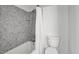 Bathroom featuring grey tiled shower and toilet with a white shower curtain at 201 Red Bud Ln, Chapel Hill, NC 27514