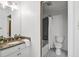 Bathroom featuring granite countertops, bathtub with tiled wall and neutral walls at 201 Red Bud Ln, Chapel Hill, NC 27514