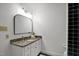 Bathroom with white vanity and granite countertop, complemented by tiled flooring and blue-tile shower at 201 Red Bud Ln, Chapel Hill, NC 27514
