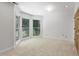 Bright bedroom featuring a bay window with views of lush greenery and neutral carpet at 201 Red Bud Ln, Chapel Hill, NC 27514