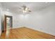 Bright bedroom with hardwood floors and ceiling fan; connected to a bathroom, offering comfort and functionality at 201 Red Bud Ln, Chapel Hill, NC 27514