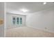 Bright bedroom with large windows and neutral carpet; has an intercom system and spacious closet at 201 Red Bud Ln, Chapel Hill, NC 27514