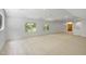 Large bonus room featuring big windows for ample natural light, neutral carpets, and bright white paint at 201 Red Bud Ln, Chapel Hill, NC 27514