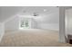 Spacious bonus room with carpet, white walls, and multiple windows offering natural light at 201 Red Bud Ln, Chapel Hill, NC 27514