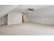 Large bonus room featuring neutral carpet, a ceiling fan, and multiple closets at 201 Red Bud Ln, Chapel Hill, NC 27514