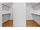 Spacious walk-in closet with wood floors and multiple shelves offering ample storage and organization at 201 Red Bud Ln, Chapel Hill, NC 27514