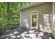 A wooden deck offers outdoor living and transitions to the surrounding lush greenery and trees at 201 Red Bud Ln, Chapel Hill, NC 27514