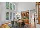Open dining area featuring large windows, hardwood floors, and custom built-in storage at 201 Red Bud Ln, Chapel Hill, NC 27514