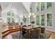 Bright dining area with large windows overlooking trees and open to living area at 201 Red Bud Ln, Chapel Hill, NC 27514