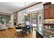 Open dining area features wood floors, a stone fireplace and plenty of natural light from large windows at 201 Red Bud Ln, Chapel Hill, NC 27514